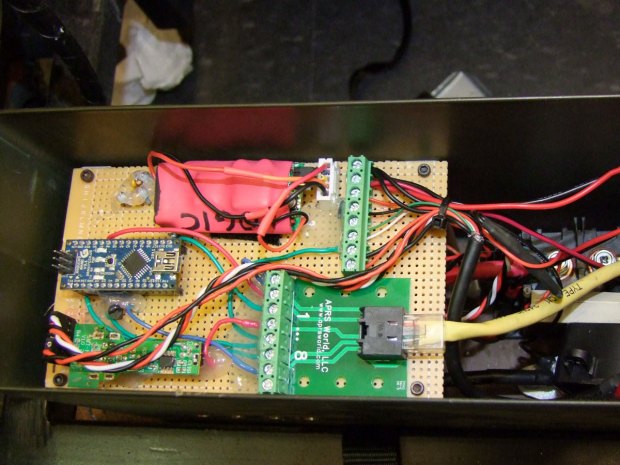The electrical deck of Chibi-Mikuvan consists of an Arduino Nano, a modified USB charger as a power supply, a high-current relay connected between the battery and motor controller, and a current sensor. The red component is a backup logic power supply.